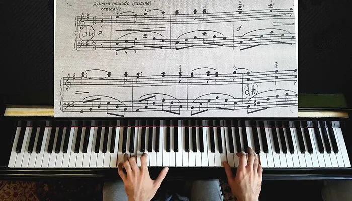 music student practicing with sheet music piano